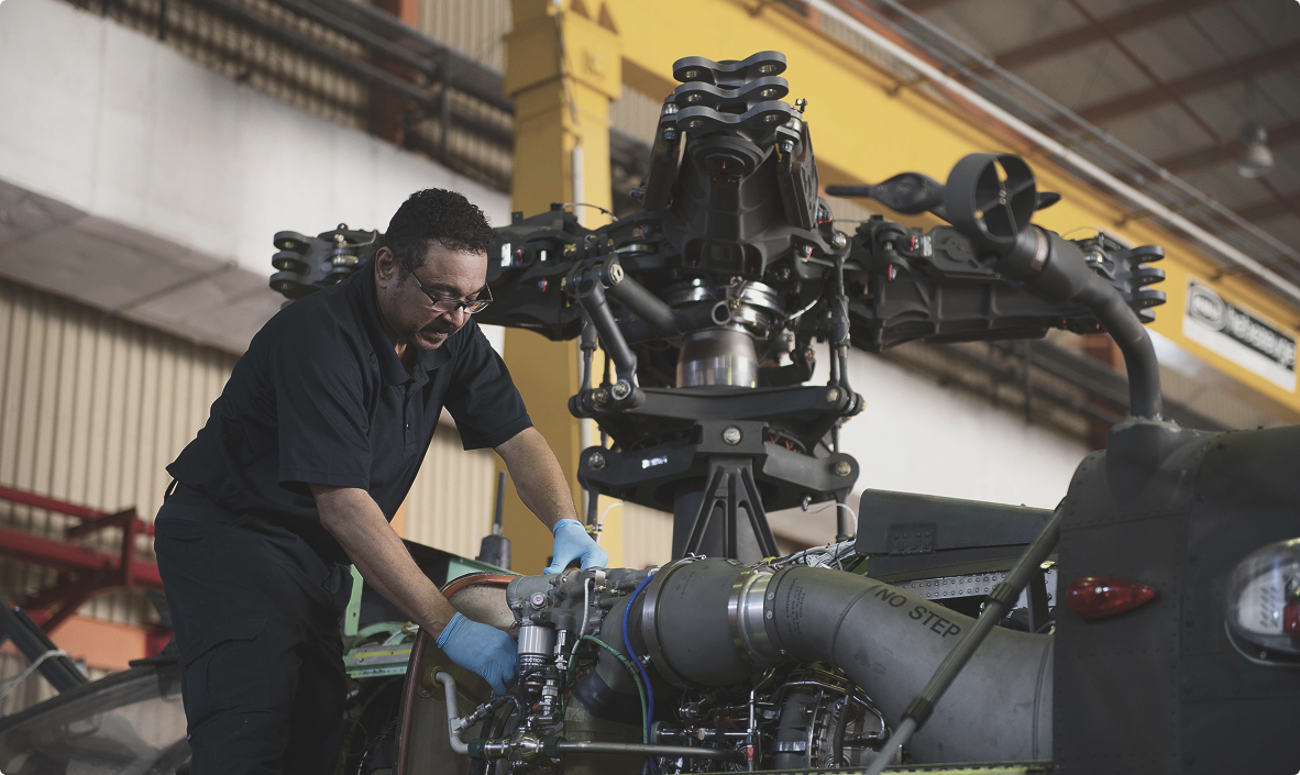 GAL technician servicing a helicopter in a hangar