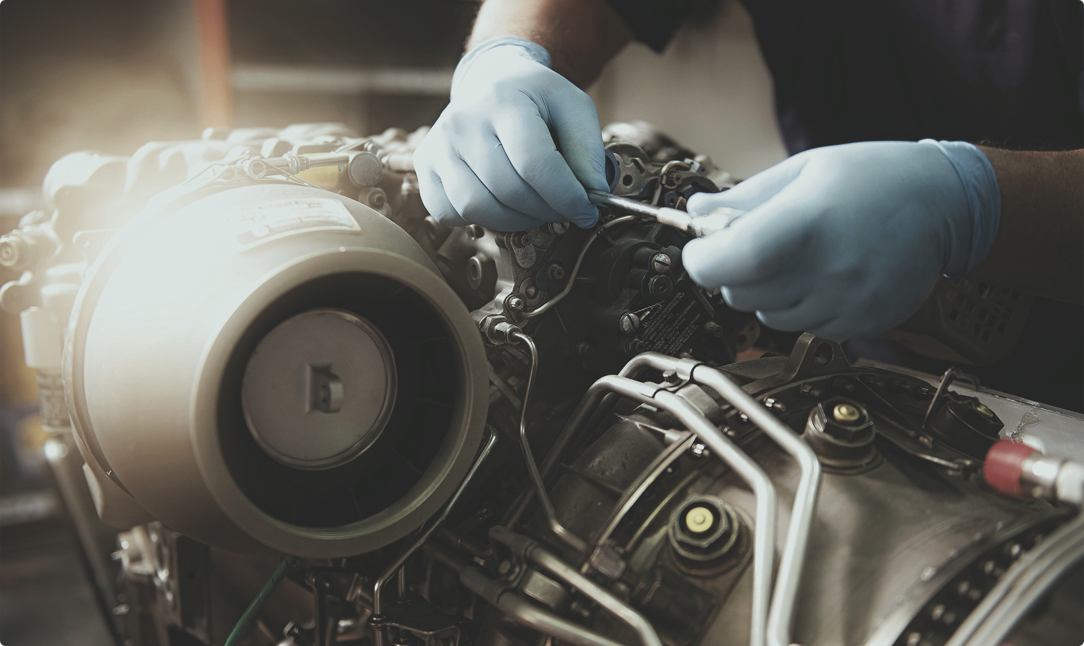 Aerospace engineer servicing an engine