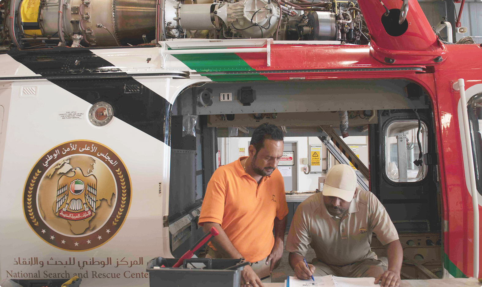 Technicians working inside a rescue helicopter