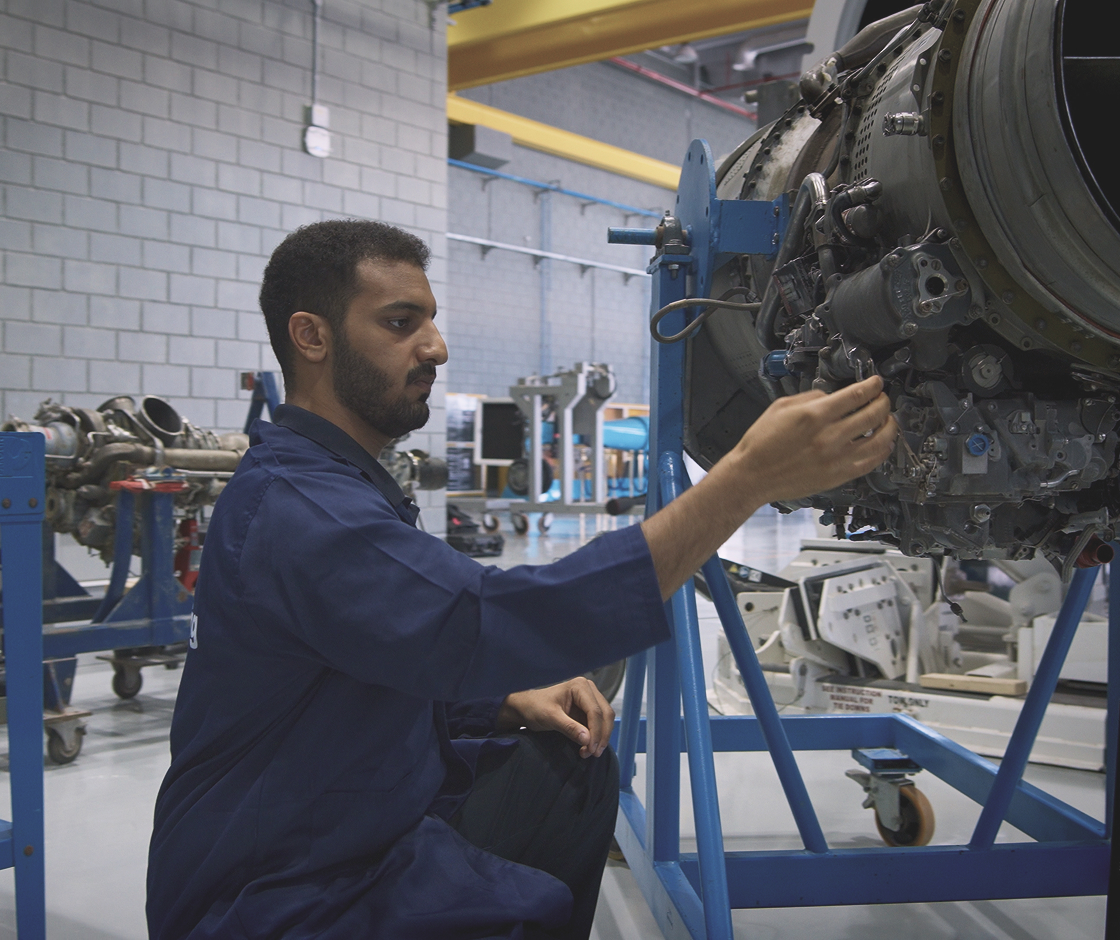Emirati aviation professional maintaining an aircraft engine