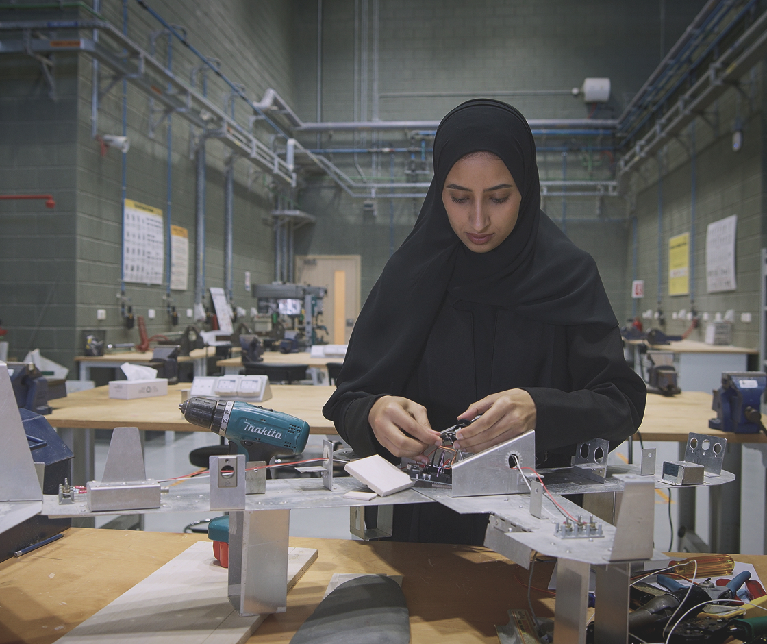 Emirati aerospace professional working on an aircraft component