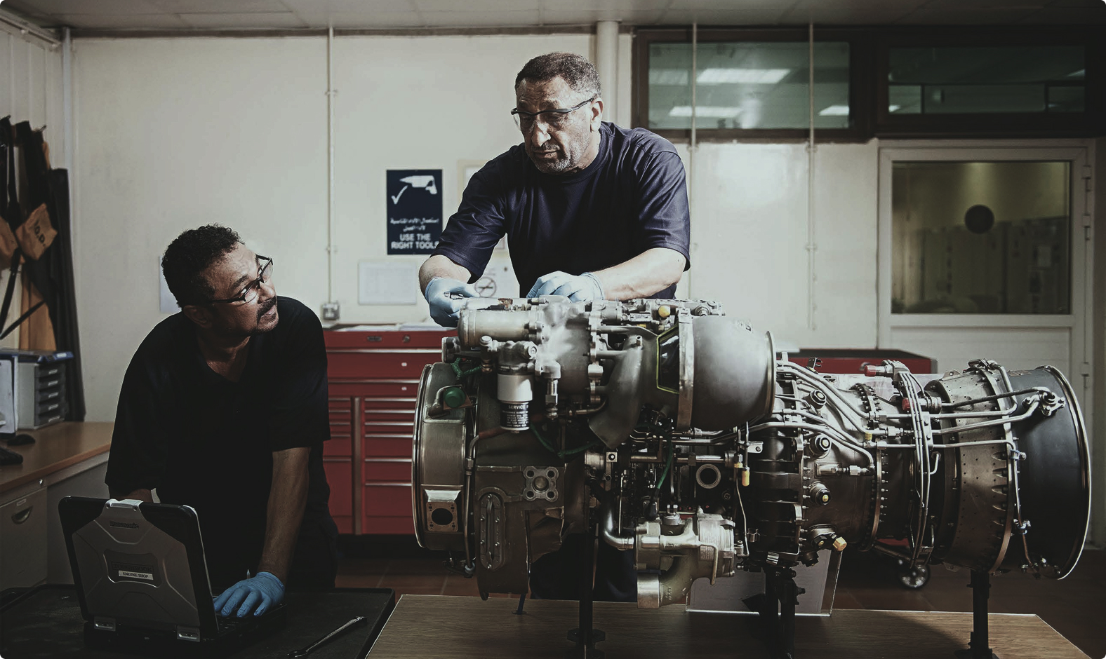 Aerospace specialists working with an engine